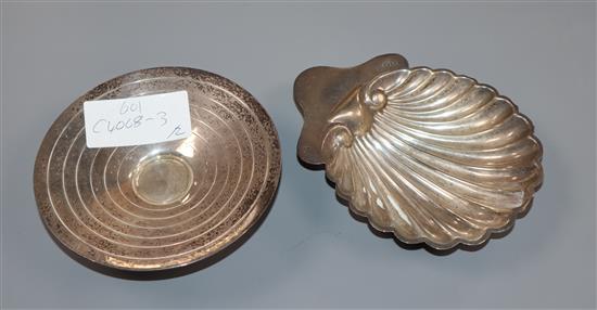 An Art Deco silver small pedestal dish by Harrods Ltd, Birmingham, 1934 and an Edwardian silver butter shell.